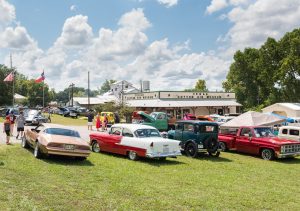 classic cars parked outside of the Texas Cotton Gin Museum in Burton Texas