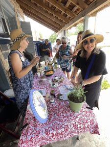 ladies under an awning tasting cheese, crackers, and wine