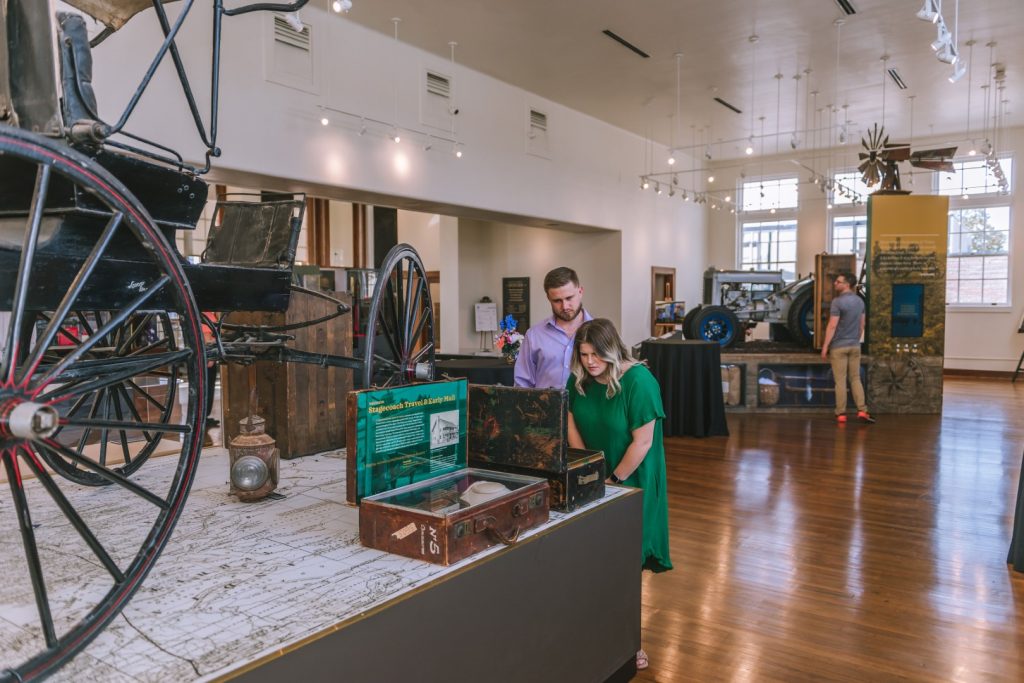 A couple looking at an exhibit at the Brenham heritage museum.