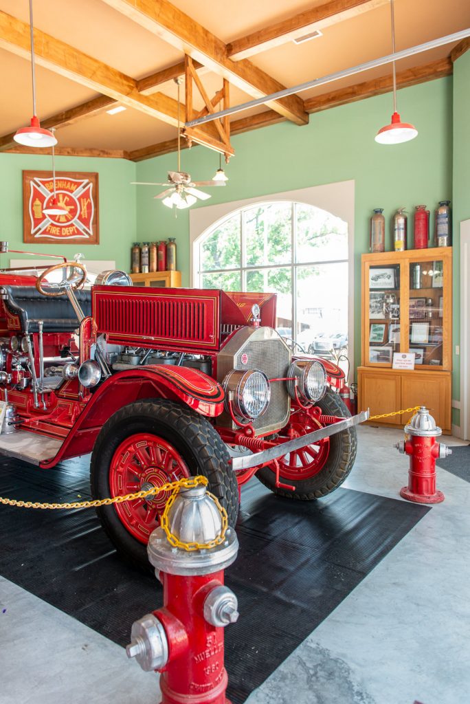 Antique red fire truck inside of the Brenham Fire Museum.