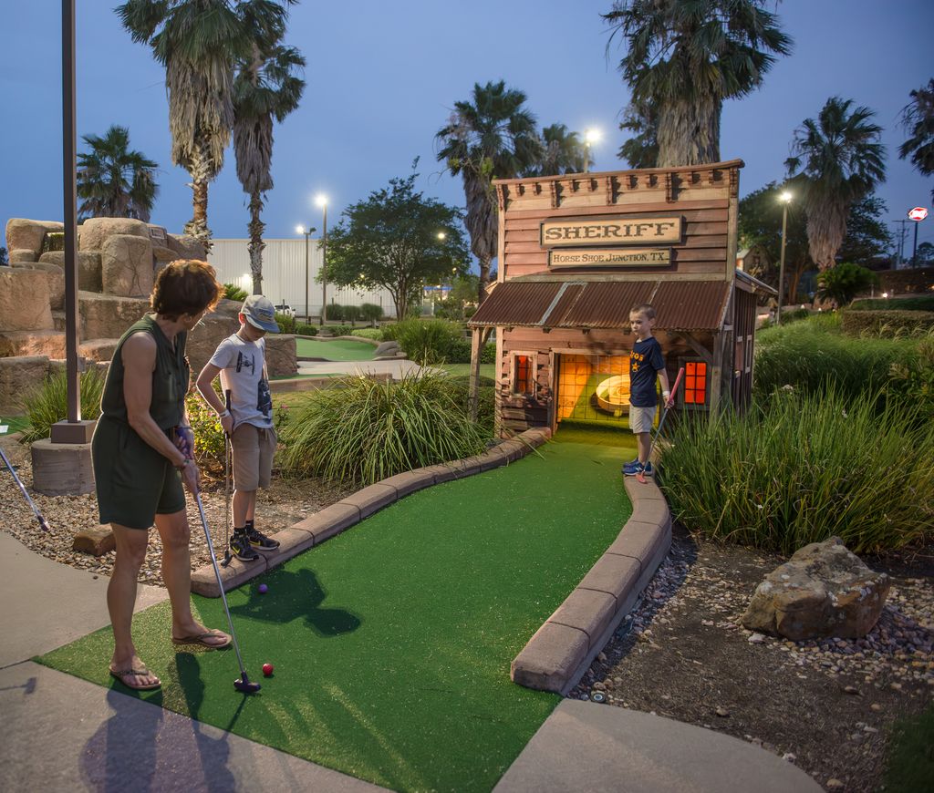 Mom and son playing mini golf at Horseshoe Junction.