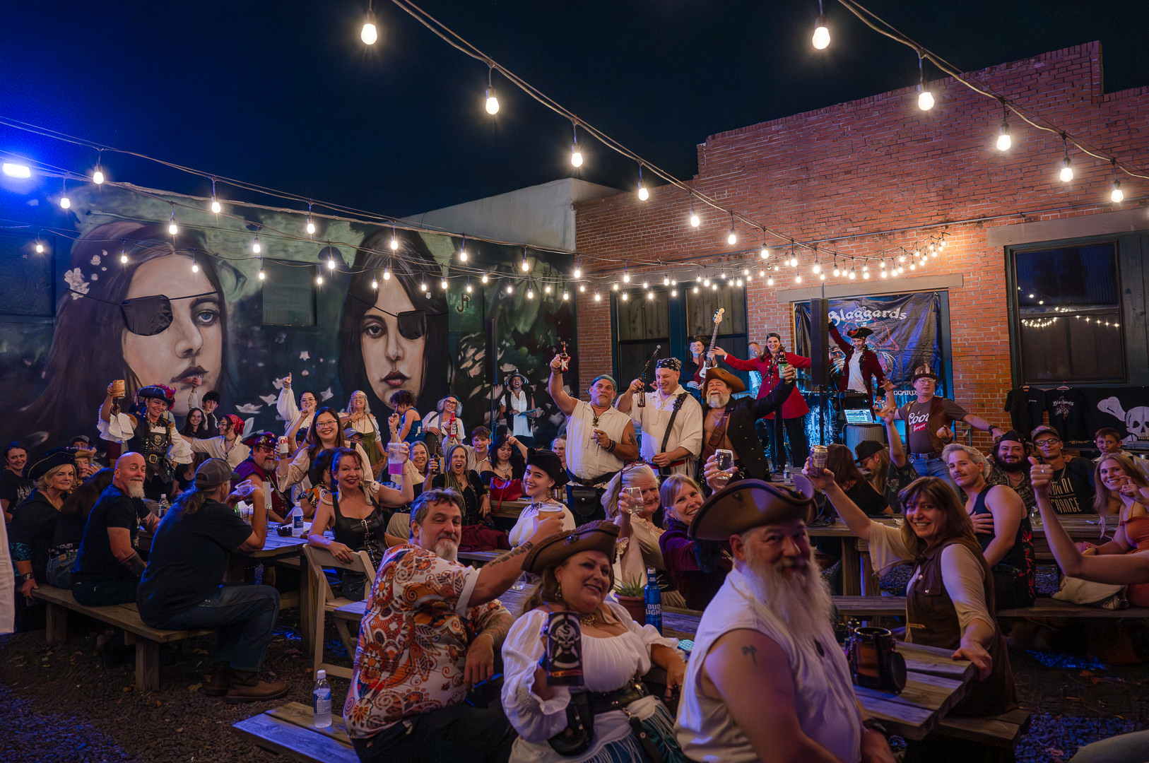 The outdoor patio is full of adults dressed in pirate attire at Pirate Fest at Home Sweet Farm Biergarten in Downtown Brenham.