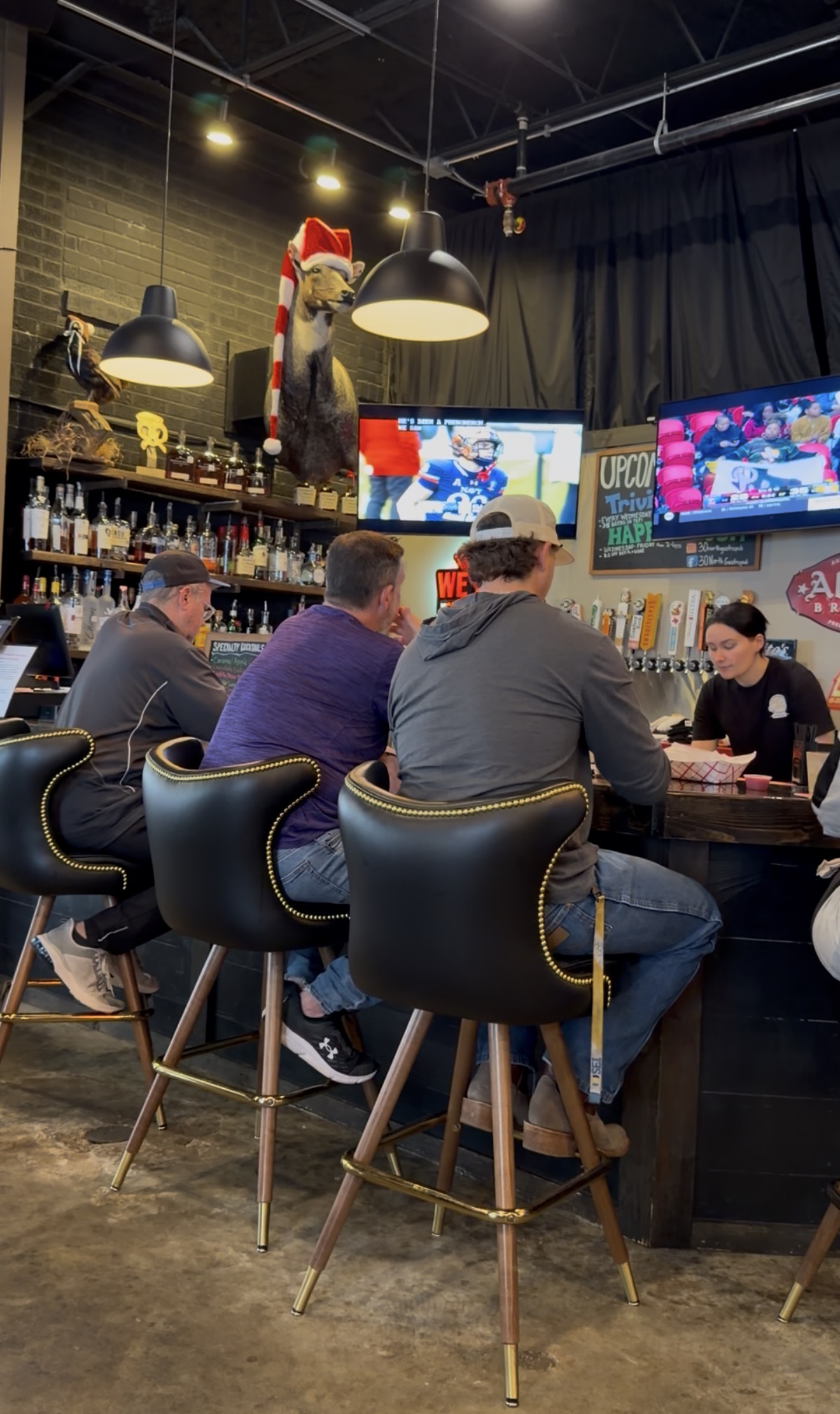 Sports are playing on TVs above the bar at 30 North Gastro Pub in Downtown Brenham, Texas. 